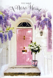 In this Richmond doorway scene, there is an almost storybook sense of arrival, the kind you might feel strolling through the tranquil streets near Richmond Green in early spring. A pale pink door stands at the centre, its gentle hue radiating warmth against the surrounding whitewashed façade. The paint has a slightly matte finish, giving the surface a soft, tactile look, as though it would feel smooth yet grounded under your fingertips. Draped above and around it is an exuberant display of wisteria, cascading in layers of lavender and soft purple, their delicate blooms hanging like clusters of tiny bells or grapes. The wisteria's slender stems and tender green leaves frame the doorway in a loose, natural arch, and the light plays through them, casting subtle, shifting shadows on the walls and step below. Sitting invitingly at the threshold, a chic grey metal bucket holds a generous bouquet of roses. These roses are a creamy blend of white and ivory tones, each flower opening into a swirl of overlapping petals that look plush and velvety. Interspersed between the blooms is a touch of fresh greenery, adding just enough contrast to emphasize the softness of the petals. A neat pink ribbon wraps around the bucket and ties into a simple bow, its colour carefully echoing the door and bringing a gentle harmony to the whole composition. The flowers appear to have been recently arranged, perhaps by Richmond Florist, and delivered as a housewarming gift for someone stepping into a new chapter of life. Everything in the image-from the trailing wisteria to the pastel door and creamy roses-combines to express a subtle but powerful message of welcome, optimism, and the quiet joy of coming home.